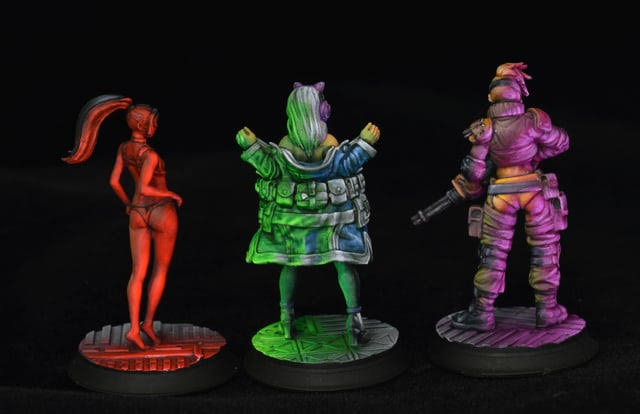 Three cyberpunk miniatures painted with directional Object Source Lighting