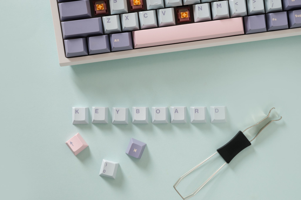 Custom mechanical keyboard with thick matte PBT keycaps in pastel lavender and blush